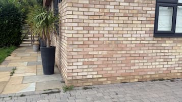 A brick building with a sign reading 'The Oasis 7a Telston Close.'