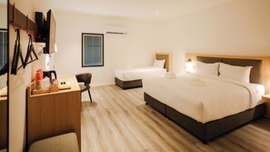 A hotel room with a large bed, a smaller bed, a desk with a chair, and a window. - B2 Muay Thai Pattaya Boutique & Budget Hotel (Pattaya)