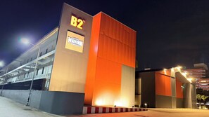A multi-story parking garage with illuminated signage and a ramp leading to the entrance. - B2 Muay Thai Pattaya Boutique & Budget Hotel (Pattaya)