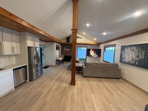 A spacious living area with a fireplace, a sofa, and a dining table.