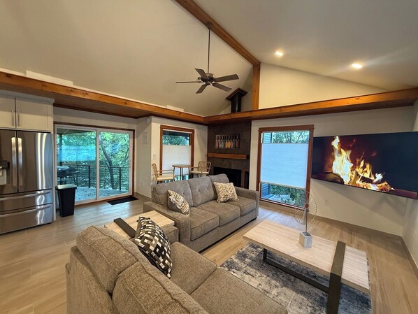 A modern living room with a sofa, coffee table, and a fireplace.