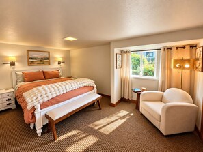 A bedroom with a bed, bedside tables, a bench, a chair, a window with curtains, and a lamp. - Historic Puget Sound Waterfront • Capitol + Marina View • Walk to Farmers Market (Olympia)
