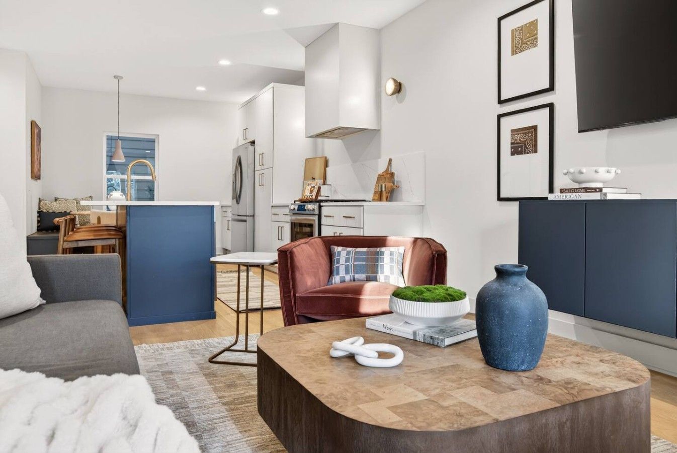 A modern living room with a sofa, a coffee table, and a fireplace.