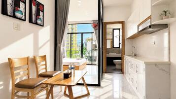 A modern hotel room with a dining area, a balcony with a view, and a separate bathroom.