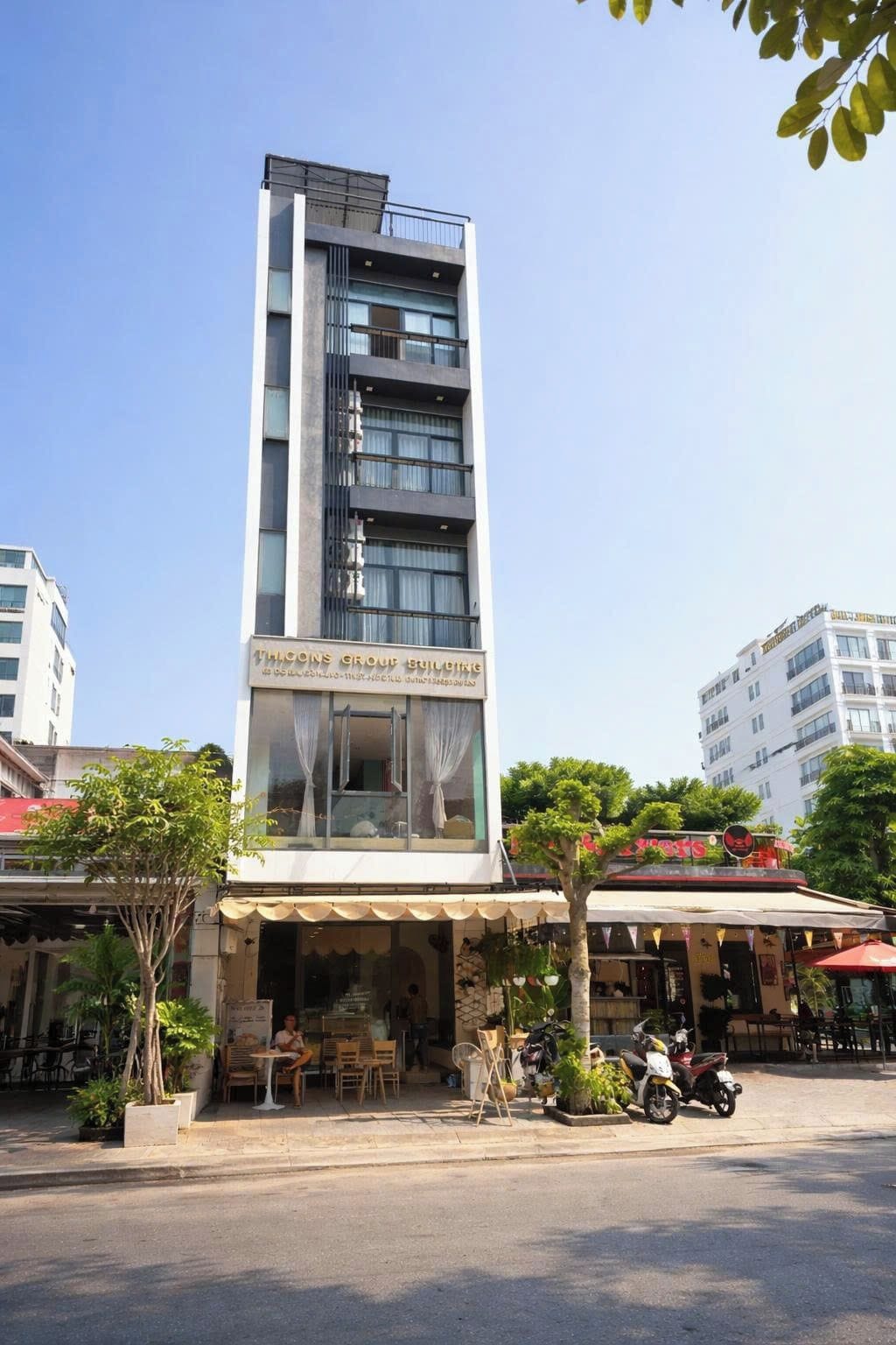 A multi-story building with a sign reading 'THILCONS GROUP BUILDING'.