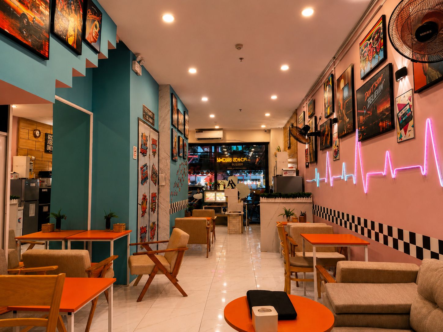A restaurant interior with teal walls, wooden tables, and chairs, and a neon heartbeat line on the wall.