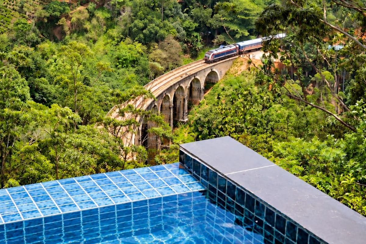 A swimming pool with a view of a bridge and forested area.