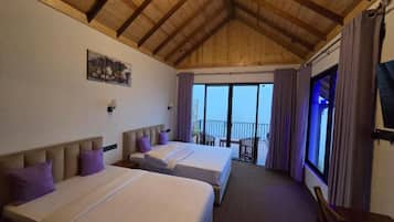 A hotel room with two beds, a balcony, and a wooden ceiling.