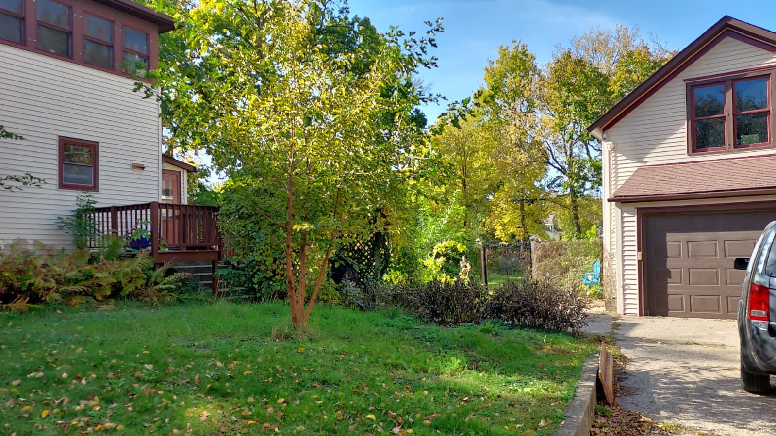 A residential property with a front yard, a garage, and a two-story house.