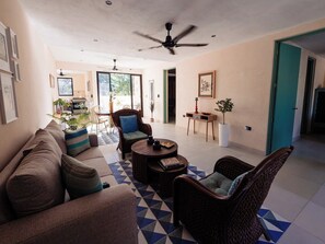 A spacious living area with a sofa, two armchairs, a coffee table, and a ceiling fan. - Casa Rita: Colonial Gem + Pool | Paseo Montejo (Merida)