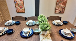 A dining table set with bowls, chopsticks, and a potted plant. - JIA Kamei Osaka (Osaka)