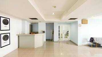 A spacious living area with a kitchen island, a dining area, and a seating space with a sofa.