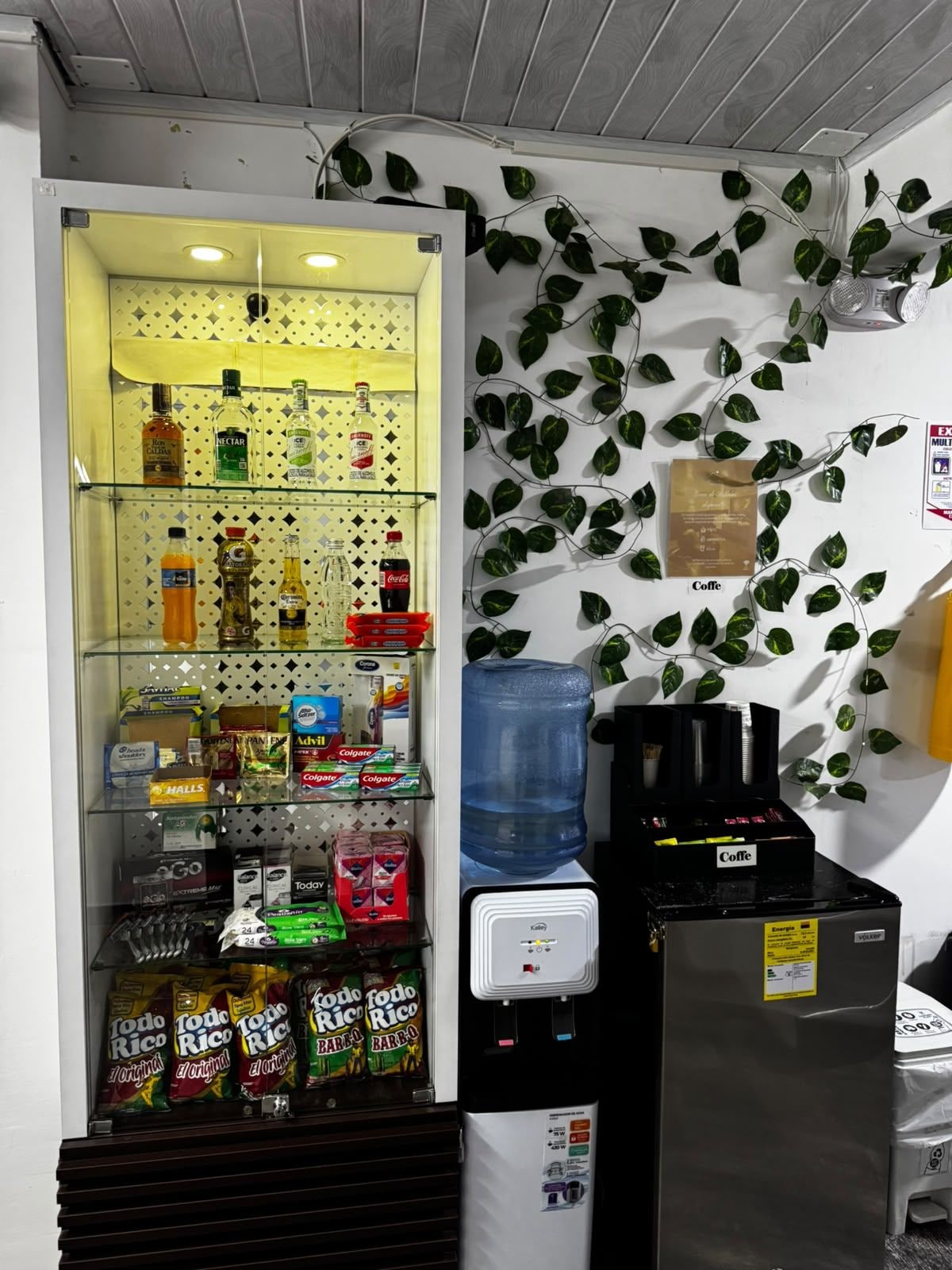 A vending machine with various snacks and beverages, a water dispenser, and a coffee machine.