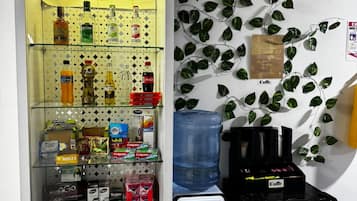 A vending machine with various snacks and beverages, a water dispenser, and a coffee machine.