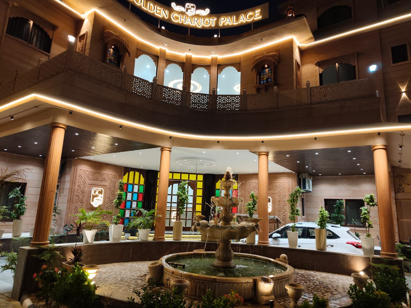 A grand entrance with a fountain, columns, and a sign reading 'Golden Charcot Palace'.