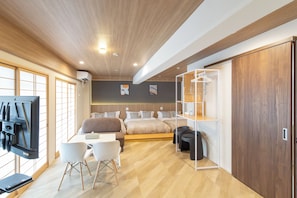 A modern hotel room with a bed, a desk, chairs, a TV, and a wardrobe. - Ocean Namba West (Osaka)