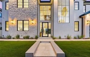 A modern two-story building with a stone facade, large windows, and a central entrance. - Valjean Hacienda By Alora Reserve (Los Angeles)
