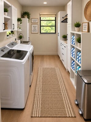 A laundry room with a washing machine, dryer, and shelves with laundry supplies. - Redlands Retreat Pool + Volleyball Sleeps 10 (Miami)