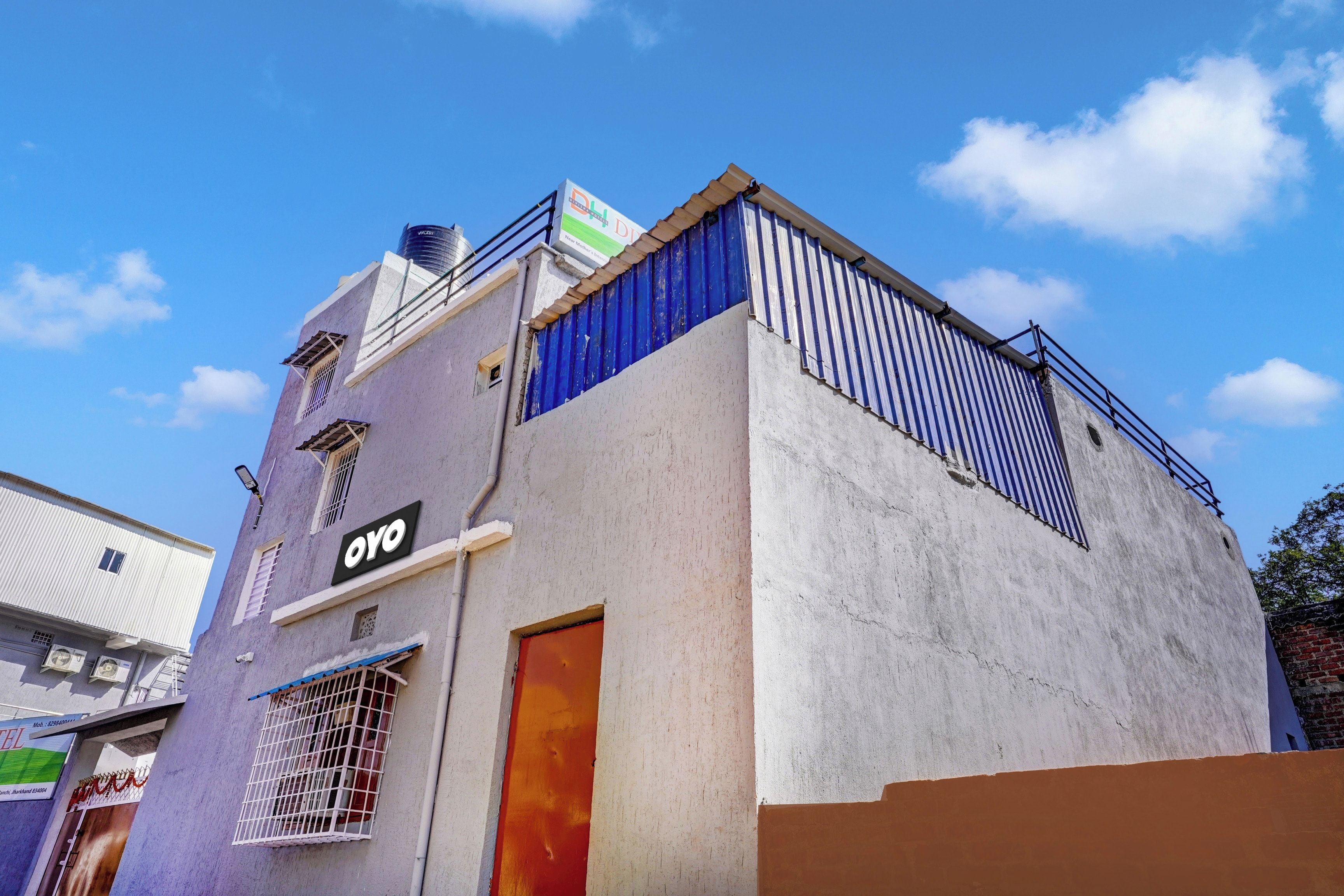 A building with a sign that reads 'OYO' and a smaller sign above it.