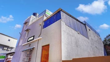 A building with a sign that reads 'OYO' and a smaller sign above it.