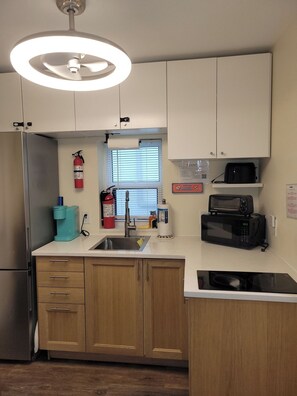 A compact kitchen with a refrigerator, microwave, toaster, and a sink. - Quiet Studio · Free Parking (Hollywood)
