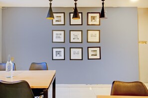 A conference room with a table, chairs, and framed pictures on the wall. - Hotel O SS Skyline (Hyderabad)