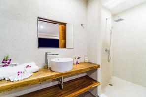 A bathroom with a wooden vanity, a white sink, a mirror, a shower, and a small Buddha statue. - Villa Moana Relaxed Tropical Retreat Samui (Koh Samui, Surhat Thani)