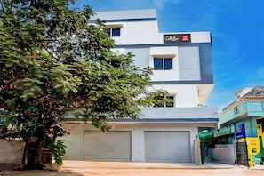 A modern building with a sign for Hotel SS Blue Inn.