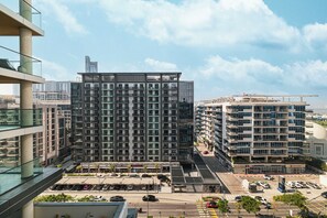A multi-story building with a modern architectural design, featuring balconies and large windows. - Premium 5BR Sobha Crest Grande (Dubai)