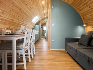 A cozy interior with a dining area, a sofa, and a curved wooden ceiling. - Willow Nook - UK52425 (Blackpool)