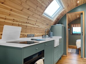 A modern kitchen with a skylight, wooden ceiling, and a view to the outside. - 1 bedroom accommodation in Blackpool (Blackpool)