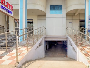 A building entrance with a sign for 'ELITE ROOMS' and a staircase leading to an upper level. - Hotel O SS ELITE (Hyderabad)