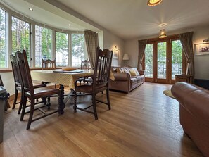 A spacious living area with a dining table, chairs, a sofa, and a couch. - Lady Bluebell - UKC10036 (St Andrews)