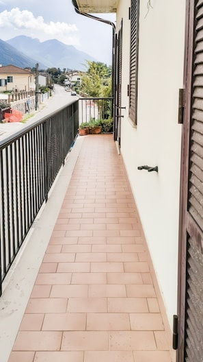 A narrow balcony with a tiled floor, a black railing, and a door on the right. - Large Family Vacation Home (Villa San Nicola)