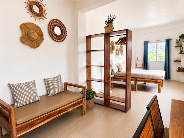 A modern living room with a wooden sofa, a wooden bench, a wooden bookshelf, and a dining table.