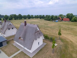 A residential area with modern houses featuring sloped roofs and white walls. - House 11 - Meadow Pipit (Am Salzhaff)