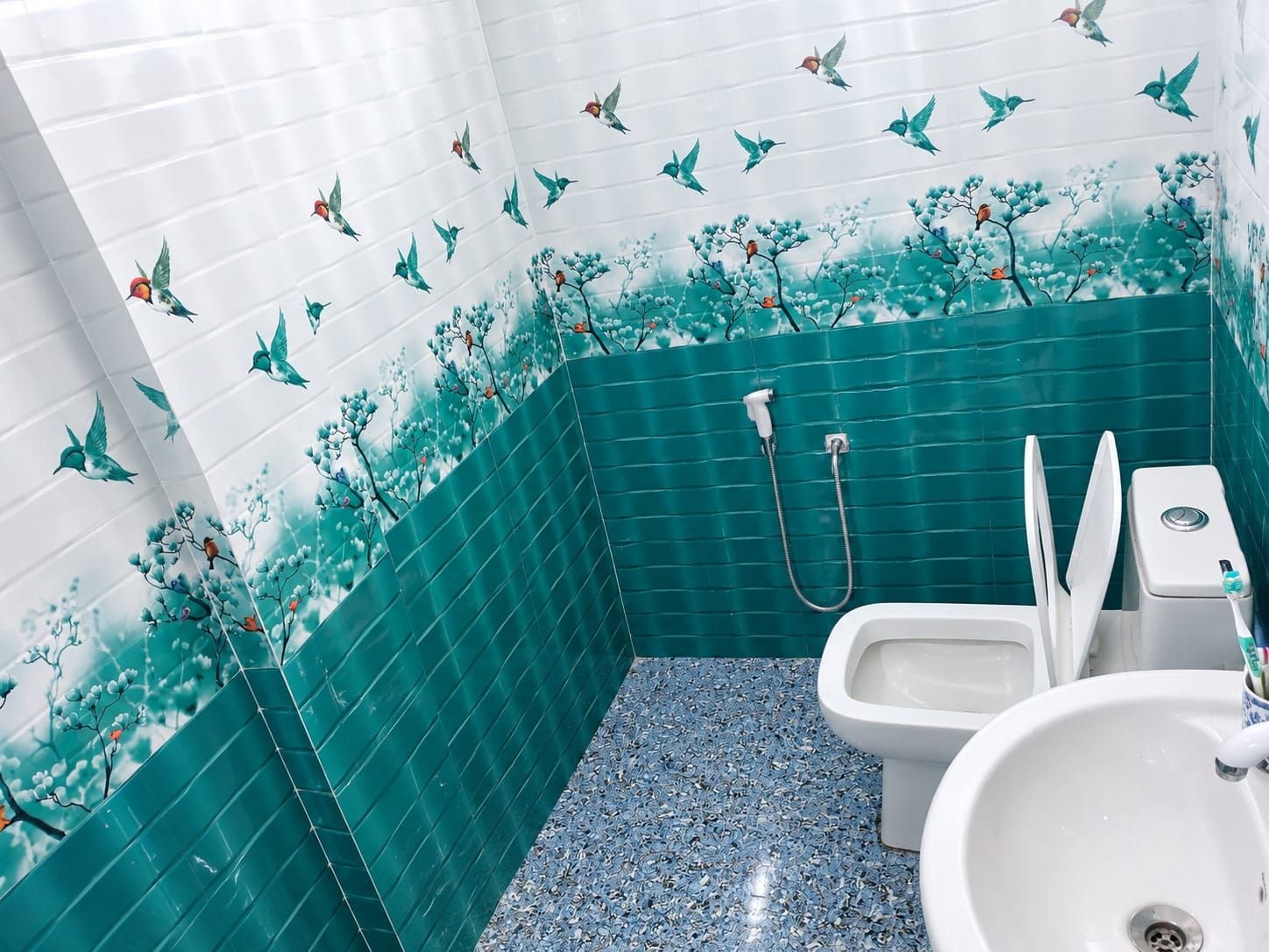 A bathroom with a shower, toilet, and sink.