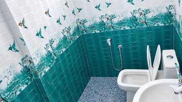 A bathroom with a shower, toilet, and sink.
