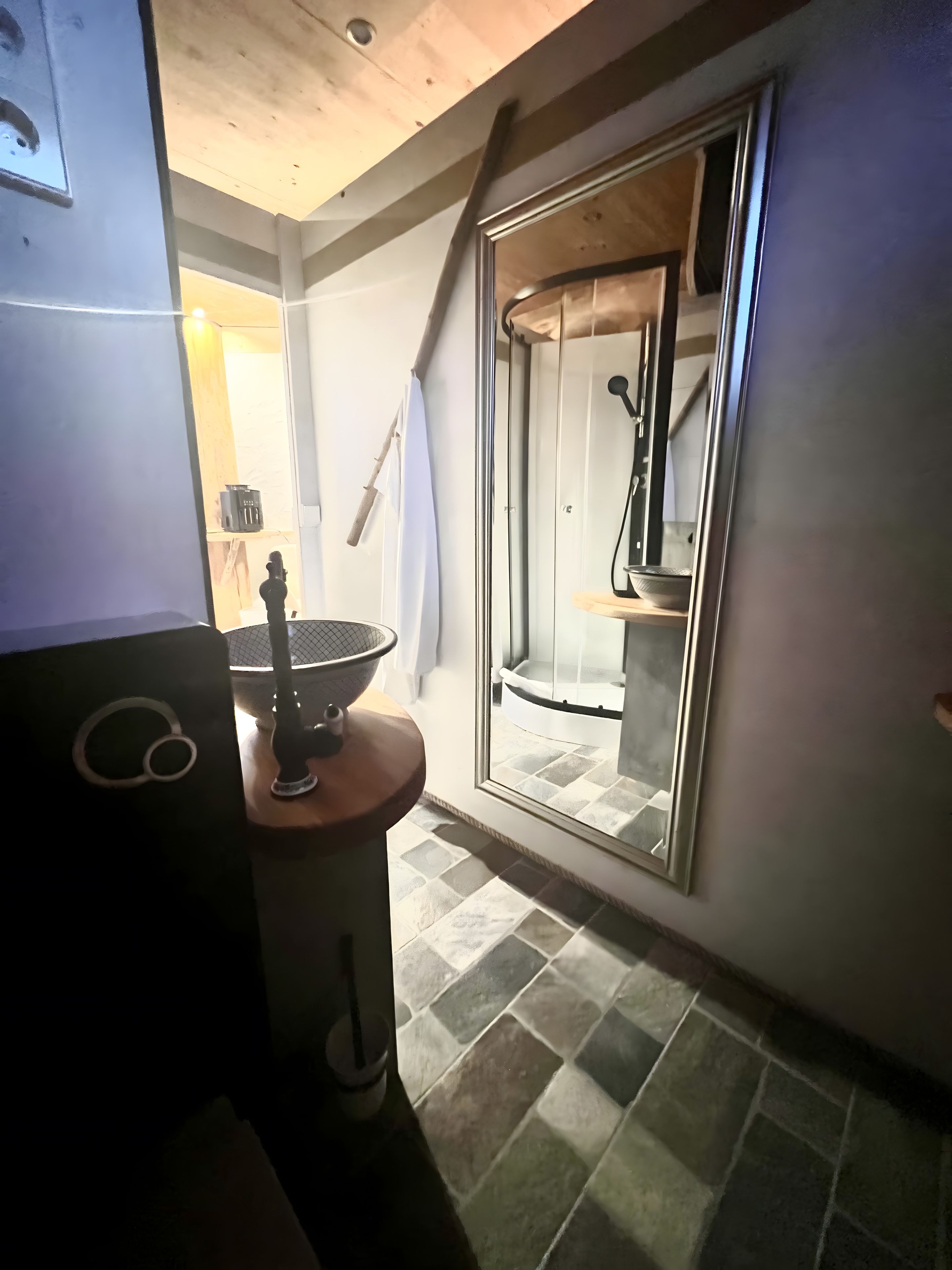 A bathroom with a shower, a sink, and a toilet.
