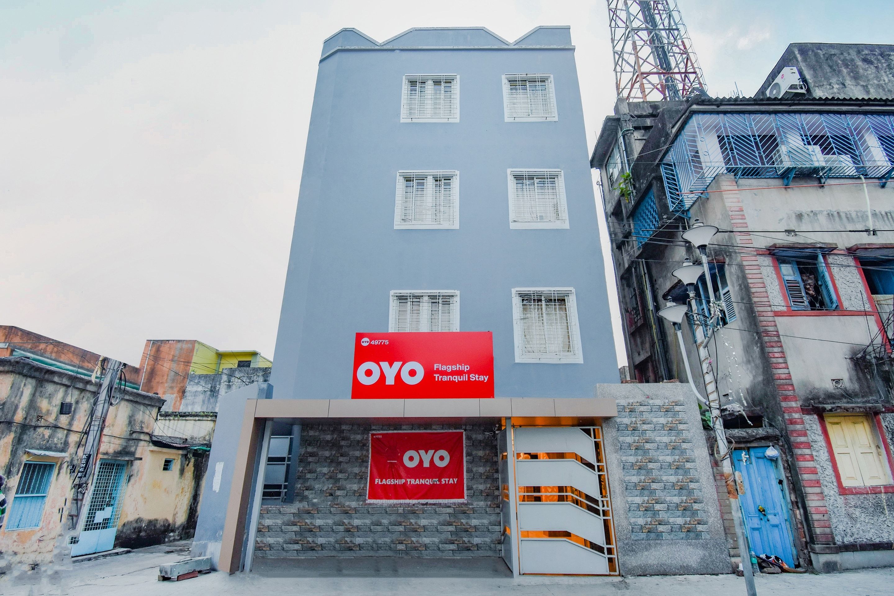 Un edificio con un letrero rojo que indica que es una estadía tranquila OYO Flagship.