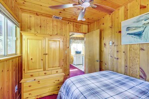 A wooden cabin room with a bed, a wardrobe, a ceiling fan, and a painting on the wall. - 1 Mi to Bear Mtn Lifts! Moonridge Alpine Cabin (Big Bear Lake)