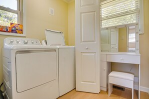 A laundry room with a washing machine, dryer, and a mirror above a vanity with a sink. - Home Near Historic Dtwn! 3 Mi to Occoneechee Mtn (Hillsborough)