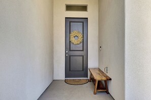 A dark-colored door with a wreath, a bench, and a doormat. - Mountain Views & Spa-Inspired! Hurricane Home (Hurricane)