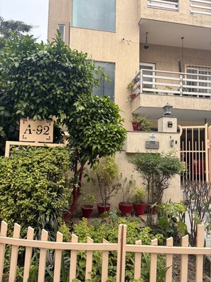 A building with a sign reading 'A-92' and a gated entrance. - Fabulous 3-bedroom floor with AC in vibrant Noida (Noida)