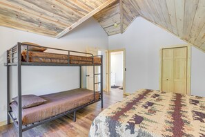 A bunk bed with a patterned blanket and a single bed with a floral quilt. - Mtn-View Deck! Ellijay Escape, Hike, Bike & Fish (Ellijay)