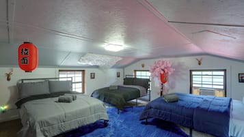A room with two beds, a window, and a ceiling with insulation.