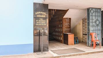 A building entrance with a sign reading 'AGRAWAL HOUSE' and 'TWO ST. GEORGES GATE ROAD CALCUTTA-22'.