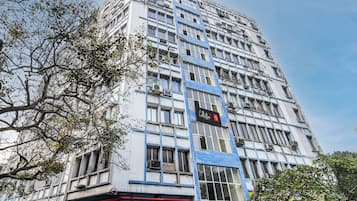 A multi-story building with a modern architectural style, featuring a prominent 'Collection' sign on the facade.