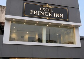 A modern building with a sign that reads 'HOTEL PRINCE INN.'