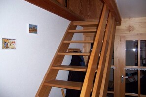 Eine Holztreppe im Innenbereich mit einer Tür am Fuß.